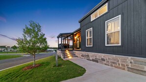 A modern building with a stone foundation and a dark exterior. - Comfortably Numb - 119 (Fredericksburg)