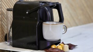 A coffee maker with a cup and chocolates on a marble countertop. - Beautiful Apartment in the Old Town - Close to the Sea (Nice)