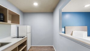 A compact kitchenette with a refrigerator, a sink, and a countertop. - Deluxe Studio at Extended Stay Cary 3 (Cary)