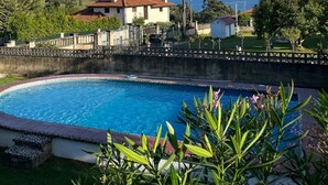 A swimming pool with a view of houses and the sea.