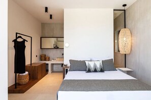 A modern bedroom with a large bed, a dresser, a mirror, and a hanging light fixture. - Award Winning Villa w BBQ, Sauna & 250m to Beach (Μυρθιανος Πλακιάς)