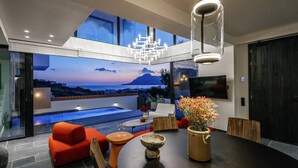 A modern interior with a dining area, a pool, and a scenic view of the ocean. - Villa w 2 pools, BBQ, Sauna,250m to Plakias Beach (Μυρθιανος Πλακιάς)
