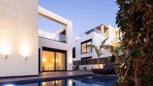 A modern two-story house with a swimming pool, large windows, and outdoor seating. - Villa w 2 pools, BBQ, Sauna,250m to Plakias Beach (Μυρθιανος Πλακιάς)