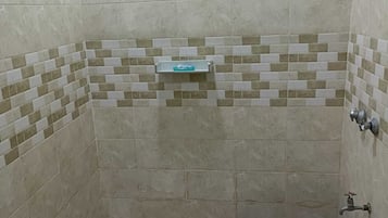 Deluxe Studio | Bathroom | Shower, slippers, towels, soap