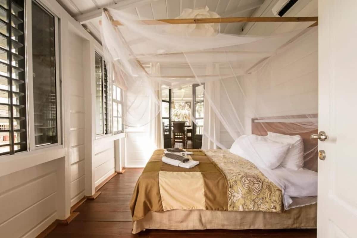 Un dormitorio con cama, ventana y puerta.