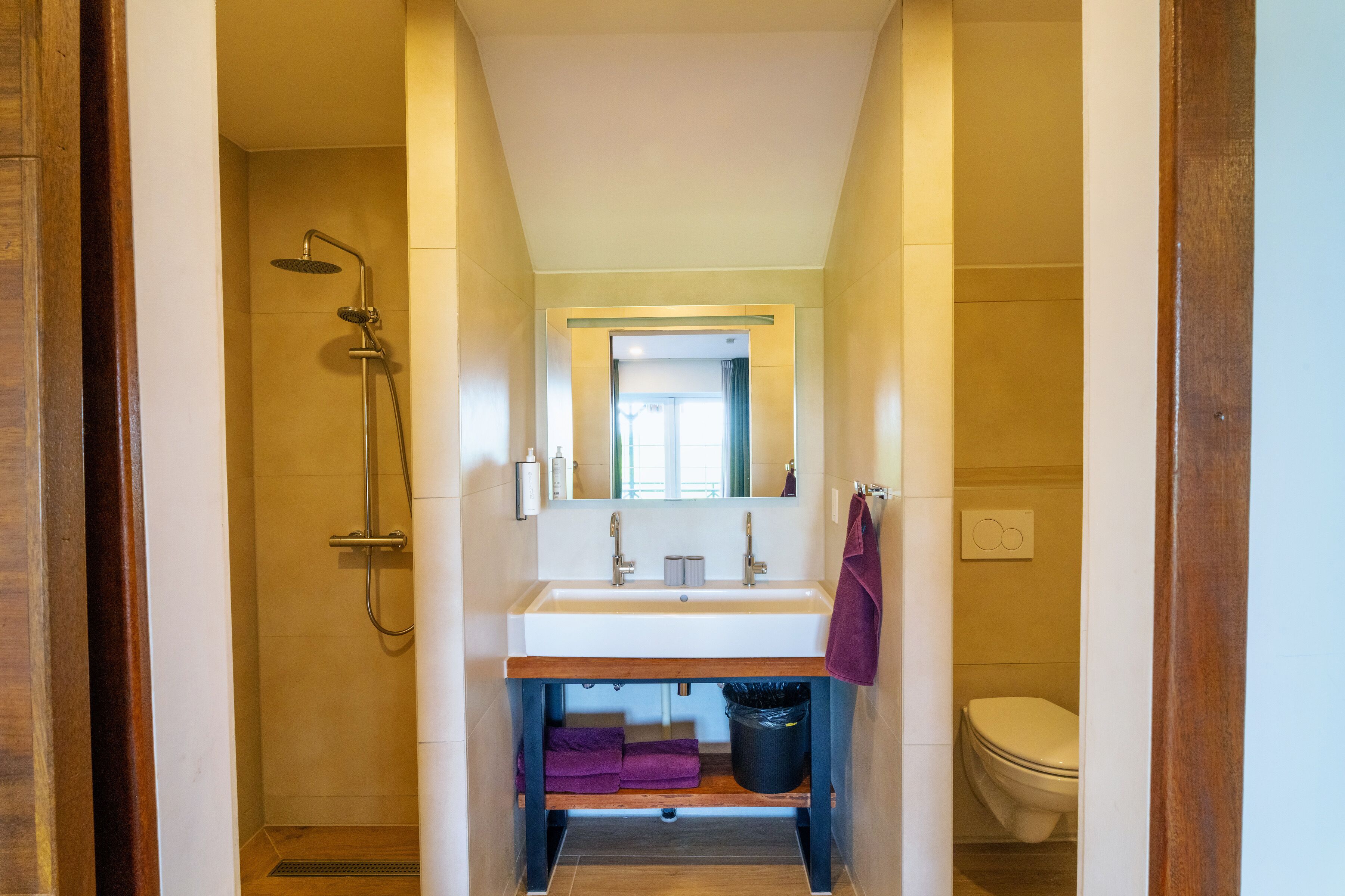 A bathroom with a shower, sink, and toilet.