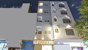 A multi-story building with a sign reading "The Sunrise Vista." - The Sunrise Vista (New Delhi)