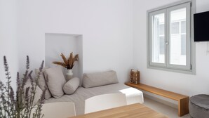 Un soggiorno moderno con un divano, un tavolo in legno e una panca.