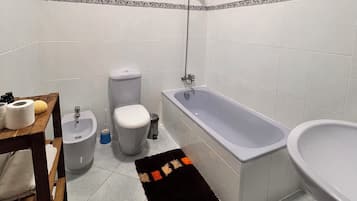 Bidet, towels, toilet paper
