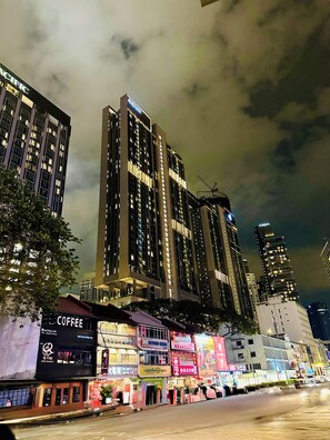 A nighttime cityscape with tall buildings, including a prominent hotel with a lit sign. - Residence Axon Bukit Bintang by TaheeenS (Kuala Lumpur)