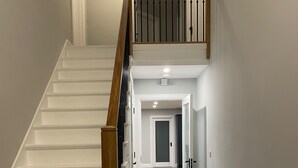A staircase with wooden handrails and white steps leading to a landing. - Spacious 5Br Home - Country View - Close to Galway (Tuam)