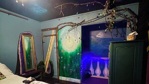 A room with a bed, a desk, a dresser, and a wall with a mural. - Your Tranquil Abode on the Holiday Road (Tipp City)