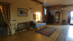 A room with a bed, a chair, a rug, a radiator, and a window. - Luxury villa in masseria- Rural hospitality (Sannicola)