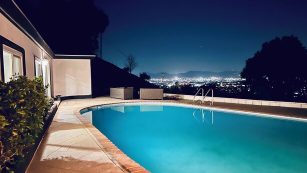 A swimming pool with a view of a cityscape at night. - Private Hillside Pool Home with View close to Yaamava and Glen Helen  (San Bernardino)