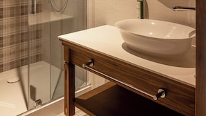 A modern bathroom with a glass-enclosed shower, a wooden vanity with a white sink, and a mirror with a wooden frame. - Willa na Kozińcu (Zakopane)