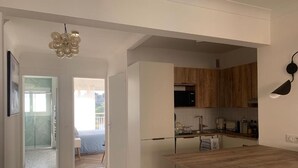 A modern kitchen with white cabinetry, a wooden countertop, and a built-in oven. - Bright, quiet apartment between the beach and Antibes old town, with parking (Antibes)