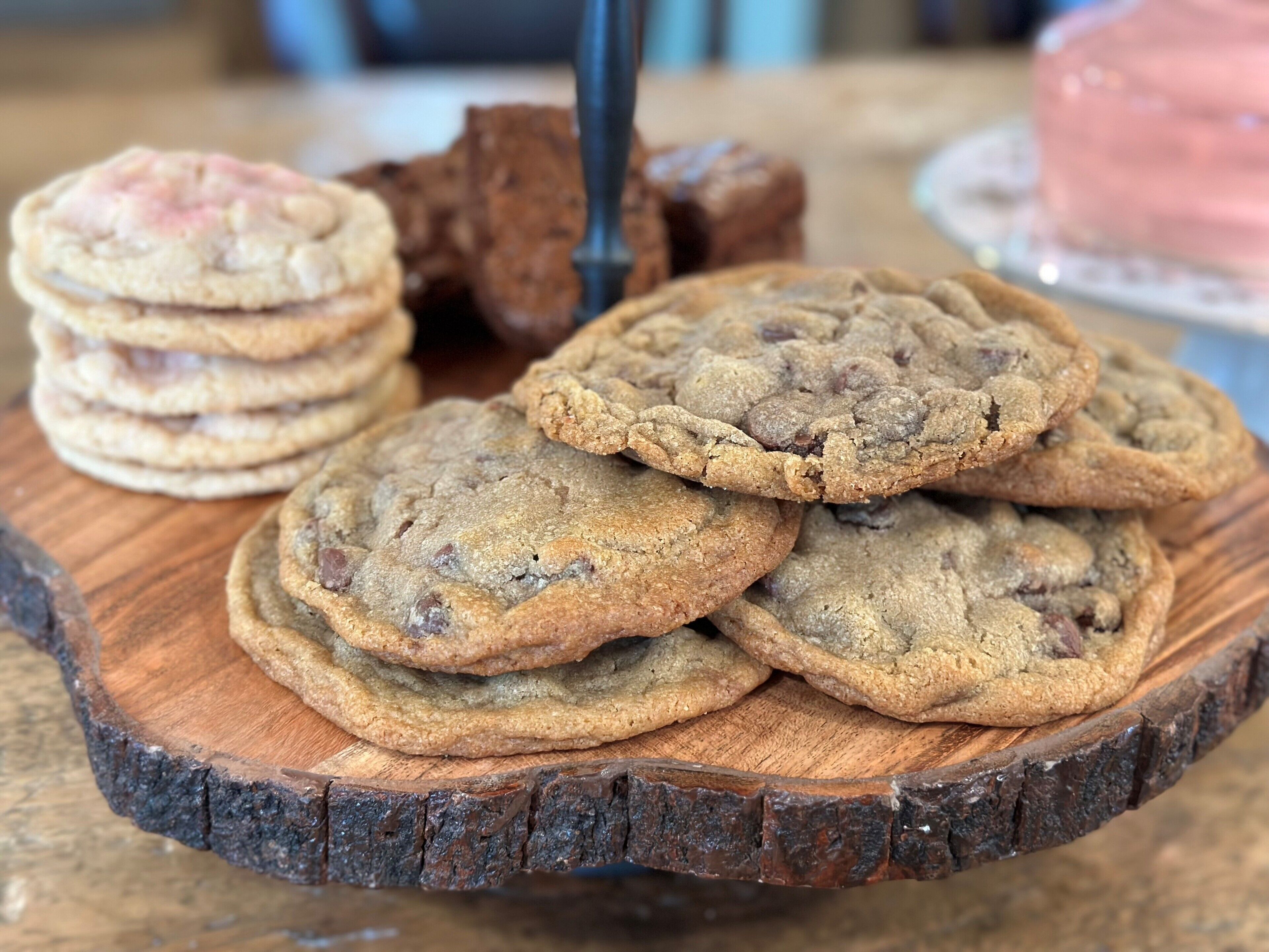 Una pila de galletas con chispas de chocolate sobre una tabla de madera.