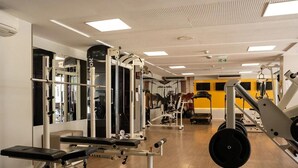 A gym with various exercise machines, benches, and weight stacks. - Solar Tambaú - LikeHome Hospedagens (Joao Pessoa)