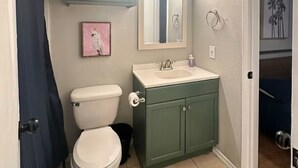 A bathroom with a toilet, sink, and cabinet. - Chic 2-bedroom apartment with WiFi, AC in enchanting Arlington (Arlington)