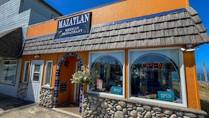 A building with a sign reading "MAZATLAN Mexican Restaurant" and a stone facade. - Whale's Spout - Pet Friendly-Depoe Bay, OR (Depoe Bay)