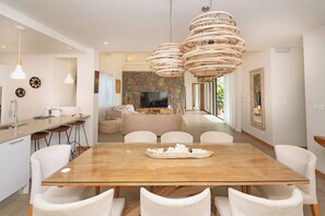 Enjoy meals in the dining area with a glass-top table and comfortable seating.