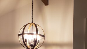 A chandelier with multiple bulbs hanging from a wooden beam. - Grand Rapids-Kentwood is close to DT and the airport. (Kentwood)