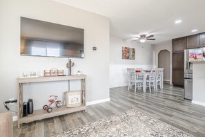 A modern kitchen with white cabinets, a built-in oven, and a refrigerator. - Pedal Paradise: Backyard Fun for Bike Lovers (Fruita)