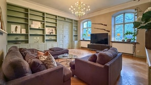 A living room with a sectional sofa, a TV, and a bookshelf. - Nice home in Ekeby with WiFi (Ekeby)