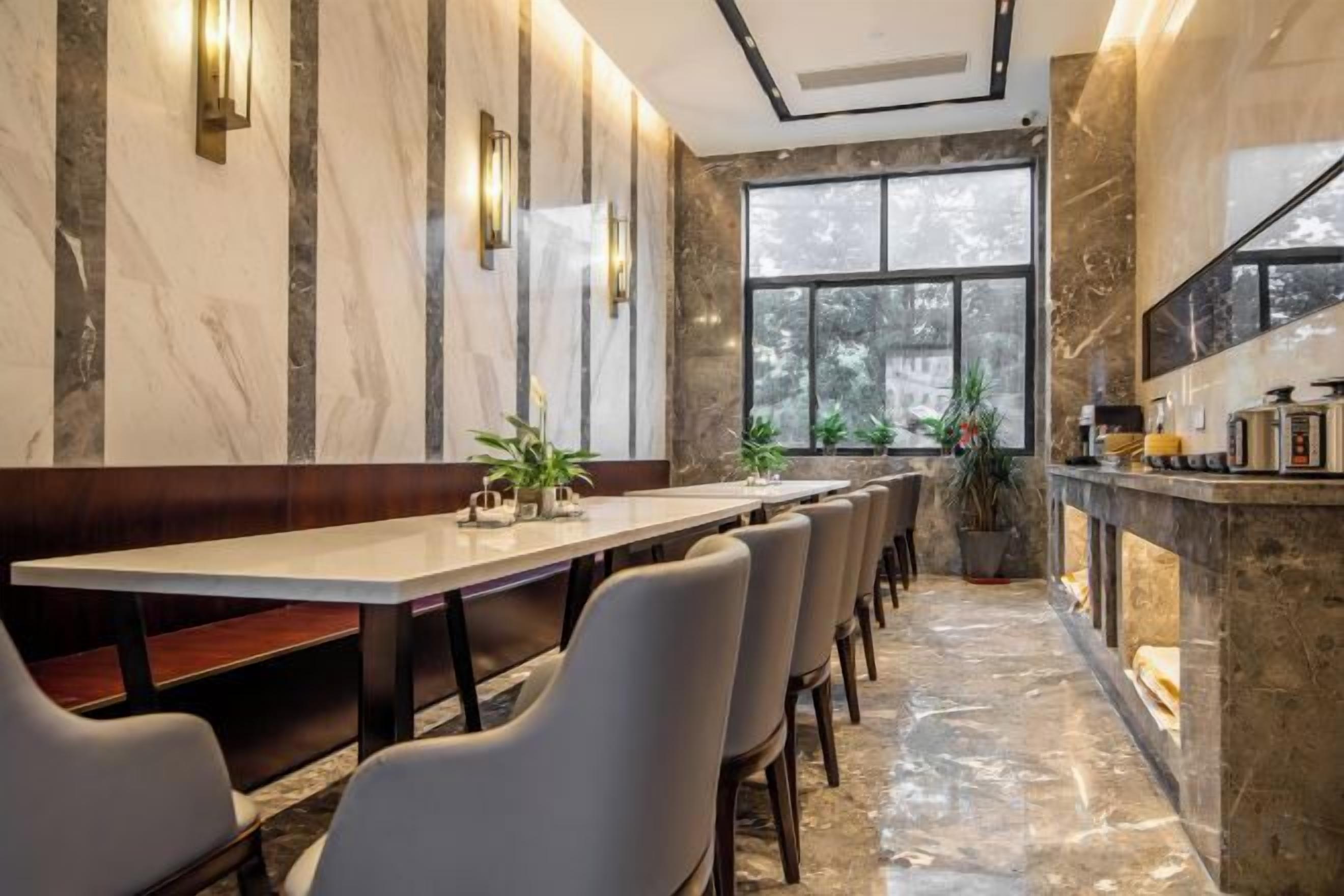 A conference room with a long table, chairs, and a fireplace.