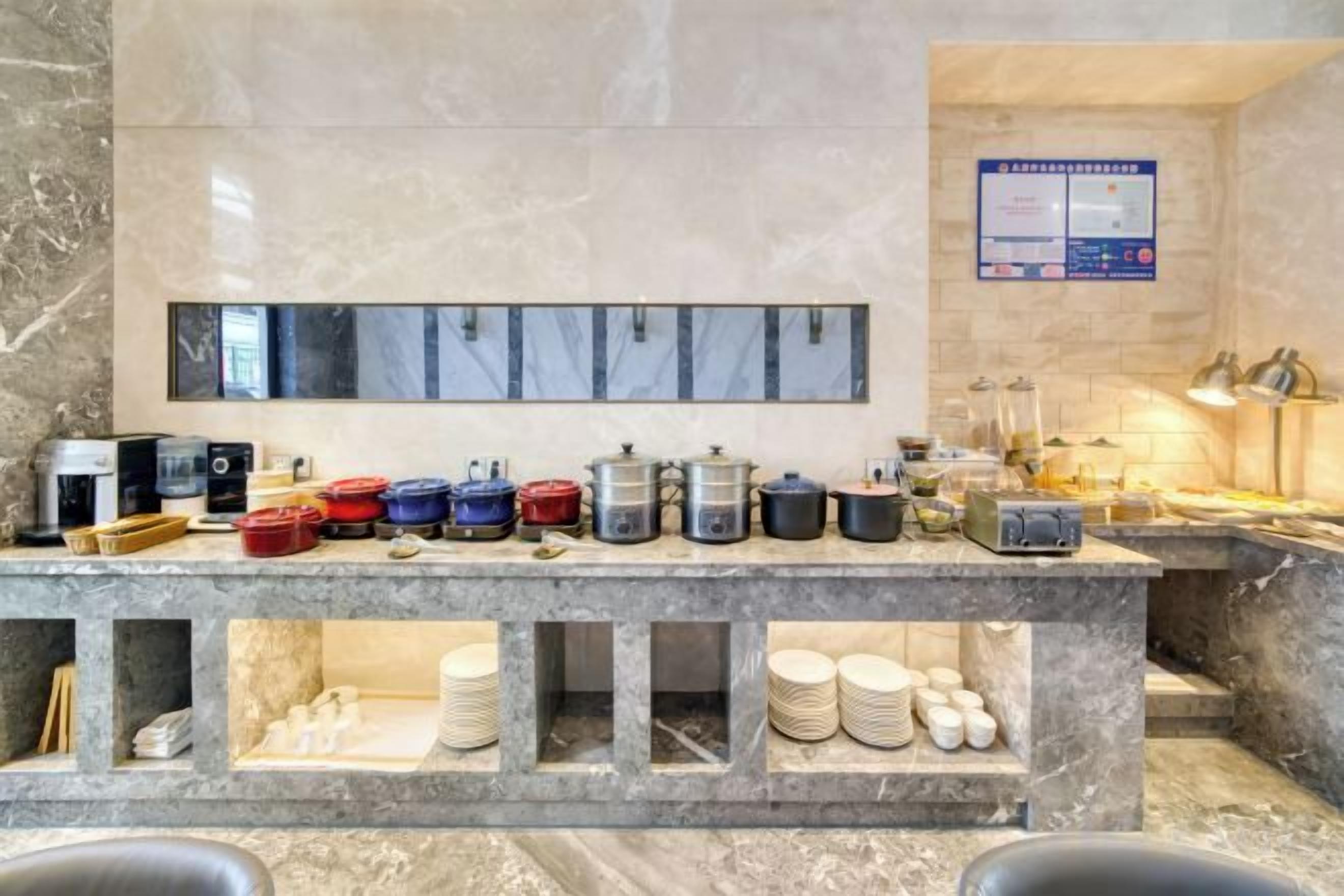 A buffet setup with various food containers and a coffee machine.