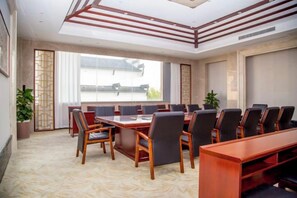 A conference room with a long table, chairs, and a view of the outdoors. - SuiningShuiyueHotel (Suining)