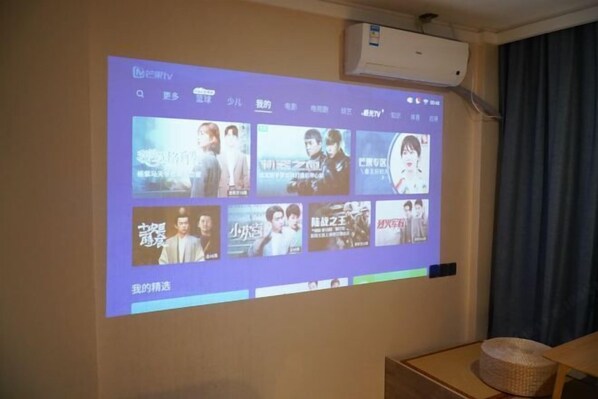 A projection screen displaying a selection of movies or TV shows. - Spacebox Hotel (Shanghai Jiao Tong University) (Shanghai)