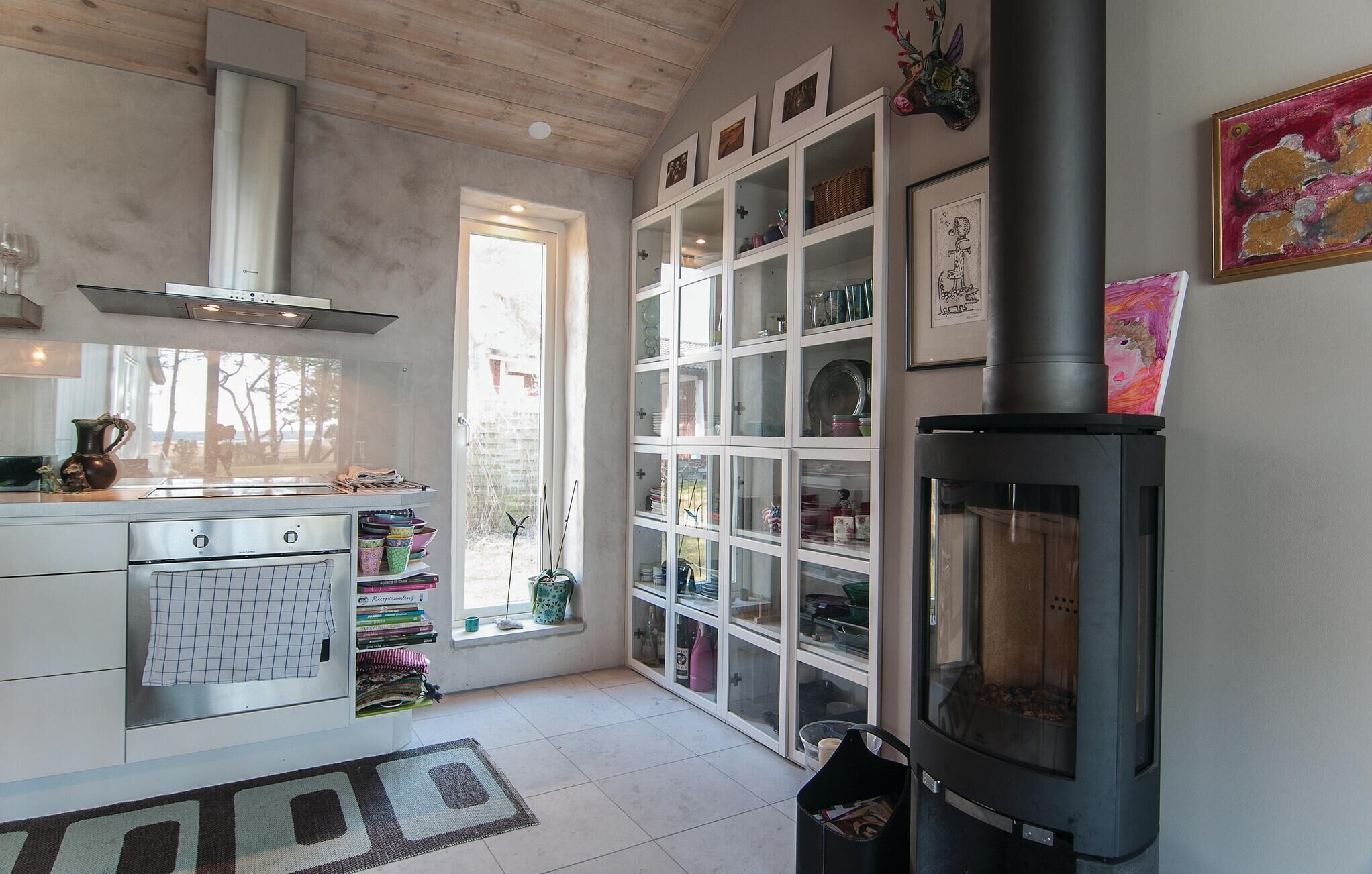 A kitchen with a stove, oven, and window.