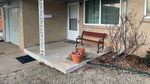 A residential house with a garage, a front porch with a bench, and a small garden area. - AIMEE'S HEART OF MOORE (Moore)
