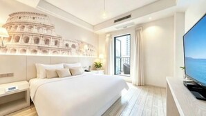 A hotel room with a large bed, a TV, a balcony with a view, and a coliseum wall decoration. - Hanxiang Hotel (Hangzhou Wenyi West Road Branch University of Finance and Economics) (Hangzhou)