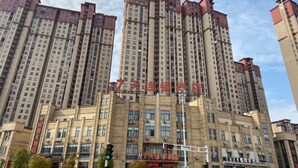 A high-rise building with multiple floors, featuring a uniform architectural style with rectangular windows and balconies. - 7Days Inn Chain Hotel (Xuancheng High-Speed Railway Station) (Xuancheng)