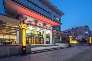 A hotel entrance with a modern facade, illuminated signage, and a welcoming entrance. - Chang'an Baiyun Hotel (Beijing)