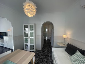 Relax in a stylish room with a comfortable bed, a small table, and a cabinet for your belongings.