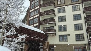 A multi-story hotel with a traditional architectural style, featuring a prominent clock tower and multiple balconies. - Amazing Copper Mountain Views! Steps to Lifts! (Frisco)