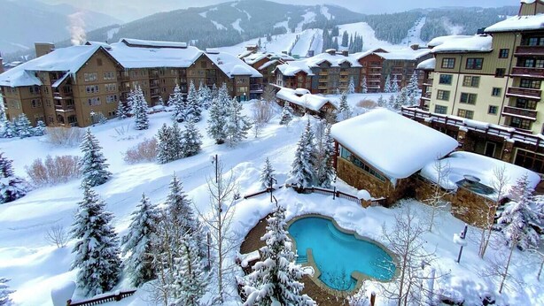 A resort with multiple buildings, a swimming pool, and snow-covered surroundings. - Amazing Copper Mountain Views! Steps to Lifts! (Frisco)