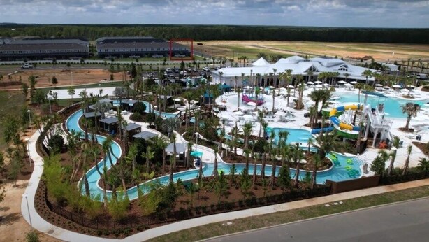 An aerial view of a resort with multiple swimming pools, water slides, and palm trees. - New beautiful 5 BEDS~Private Pool (Clermont)