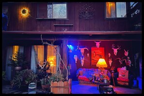 A cozy interior with a wooden ceiling, a sofa, and various decorations including skulls and plants. - Charming bungalow with an Amazing view of Sequoia National Park in Three Rivers. (Three Rivers)