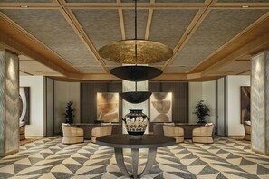 A lobby with a round table, a large vase, and a hanging light fixture. - Amoh, A Luxury Collection Resort, Rhodes (Rhodes)