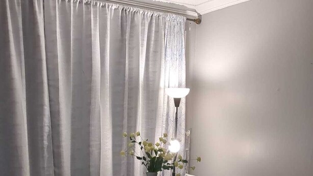 A dining table with six chairs, a vase with flowers, and a lamp in a room with wooden flooring and a curtain. - Whole House: Fair Price Great Amenities (Richmond Hill)