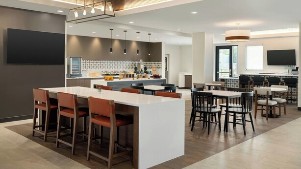 A modern kitchen with a central island, bar stools, and pendant lighting. - Towneplace Suites By Marriott Lancaster, PA (Lancaster)