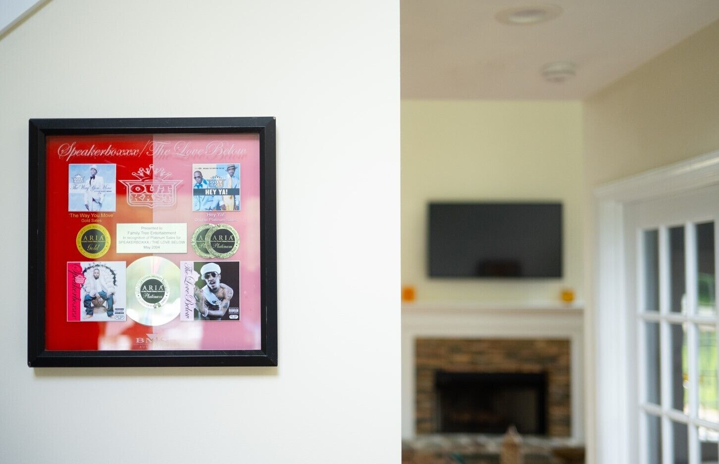A framed collage on a wall with various memorabilia and awards.