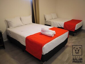 Two single beds with white bedding and red accents, a pair of rolled towels, and a logo for Hotel Balam Puerto. - Hotel Balam Puerto (Ciudad del Carmen)