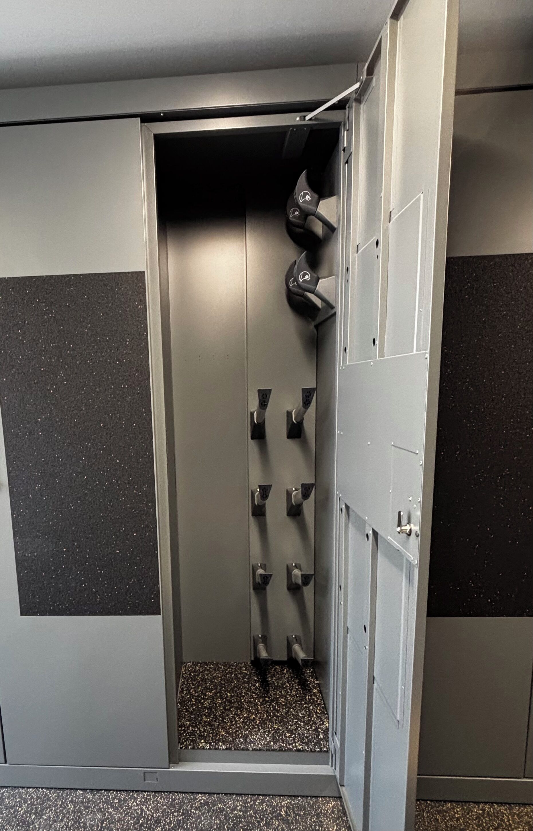 A secure storage unit with a metallic door, a small step, and a handle.