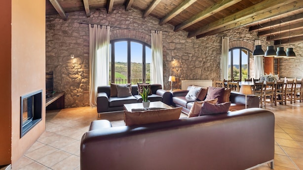 A spacious living area with stone walls, wooden beams, and comfortable seating. - Country House 'Casamira' with Mountain View, Private Pool and Wi-Fi (Unknown)