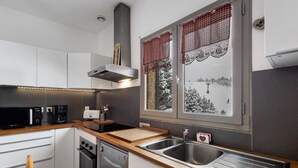 A modern kitchen with a microwave, coffee maker, and dishwasher.